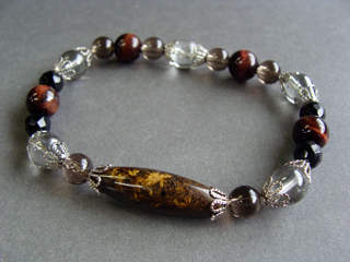 ブレスレットです。（シリコンゴム（２重・結び技法）使用・内周16.0ｃｍ）　ブロンザイト（ブロンズ）誠実・正義・努力　スモーキークォーツ（ブラウン）リラックス効果・豊かな感受性　クォーツ【シルバーフラッシュクリスタル】（クリアシルバー）健康・能力・明晰・完璧・宇宙的意識・感受性・沈着冷静・豊かな感受性　カルセドニー【オニキス】（ブラック・カット）意志の強さ・冷静さ・喜び・勉強・達成能力・調和・柔軟・目的意識・完璧さ・集中力・運動能力　タイガーアイ（レッド・虎目）集中力・健康・社交性・人間関係・直感力・金運